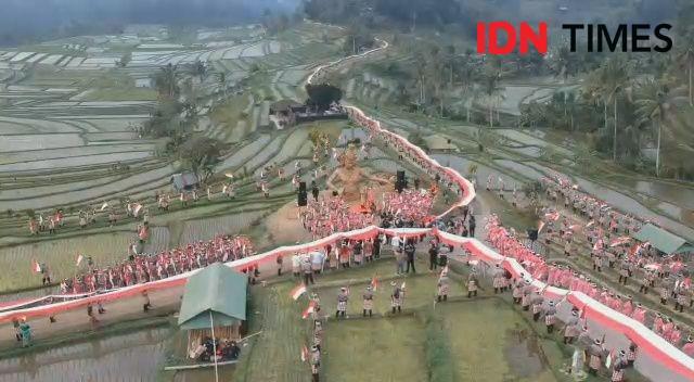 Polda Bali Bentangkan Kain Merah Putih Sepanjang 1945 meter di Sawah