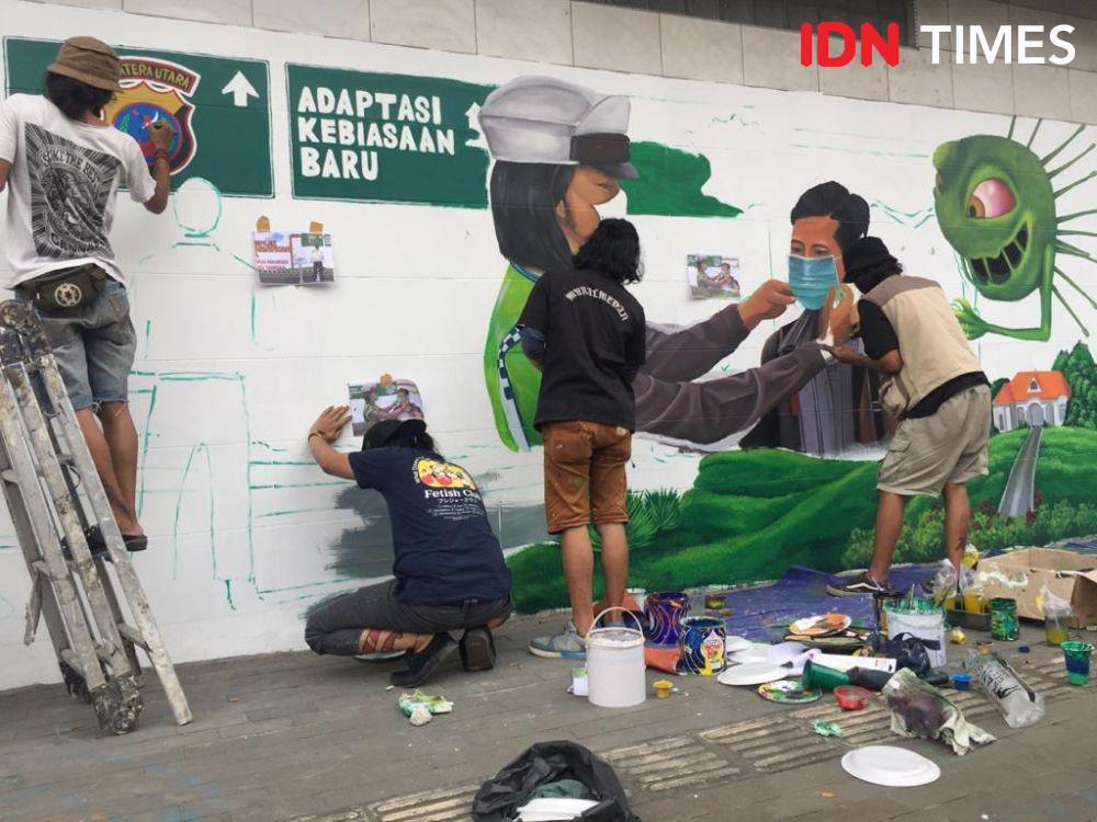 Generasi Millenial Medan Ingatkan Warga Pakai Masker Lewat Mural