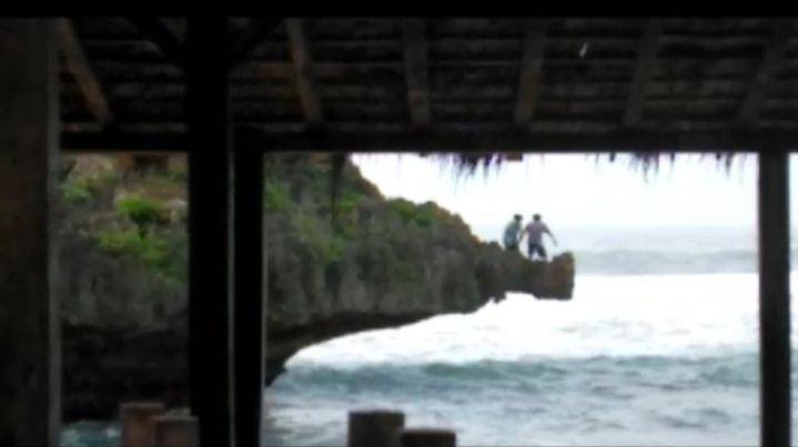 Wisatawan terjun dari tebing ke laut di Pantai Ngandong, Gunungkidul. instagram/@updatedisini