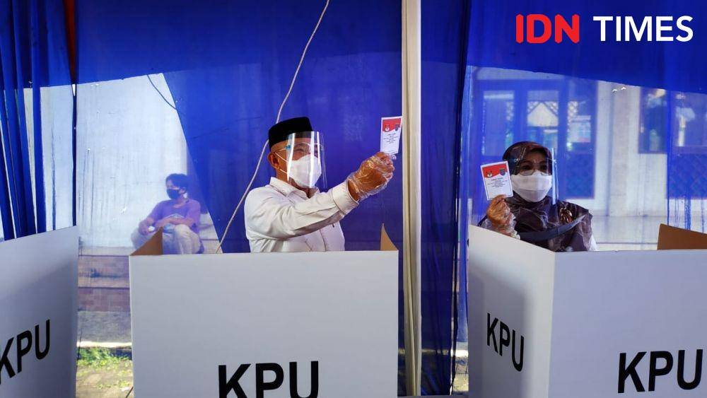 Mohammad Idris saat memasukan surat suaranya ke dalam kotak suara yang disediakan KPPS di TPS 14, Kelurahan Jatimulya, Kecamatan Cilodong, Rabu (9/12/2020) (IDN Times/Dicky)