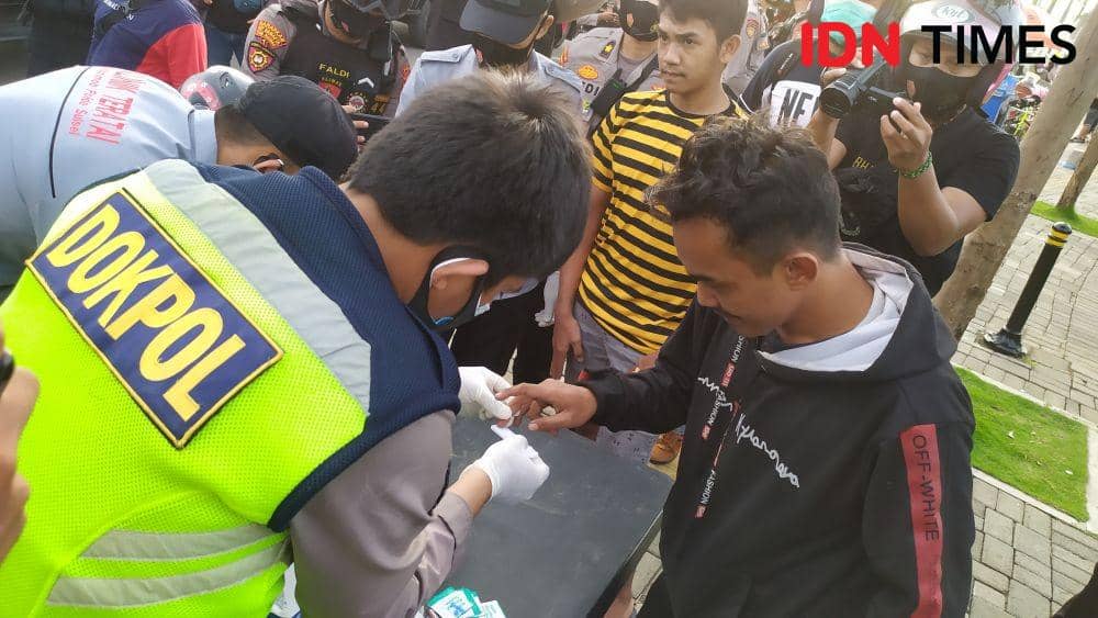 Brimob Polda Sulsel dan tim gabungan merazia pelanggar protokol kesehatan di anjungan Pantai Losari. IDN Times/Sahrul Ramadan
