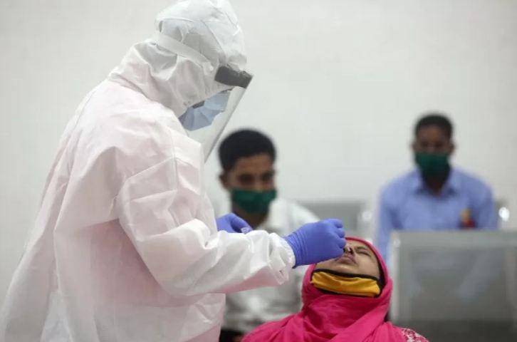 Petugas kesehatan memakai alat pelindung diri saat melakukan uji usap pada seorang wanita di Mumbai, India, Selasa (1/12/2020). ANTARA FOTO/REUTERS/Francis Mascarenhas/HP/djo. Sumber: antaranews.com