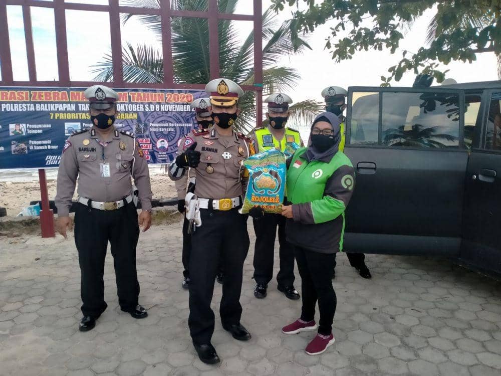 Kompol Irawan menyerahkan bantuan untuk pelaku ojek online. (Dok. IDN Times/ Istimewa)