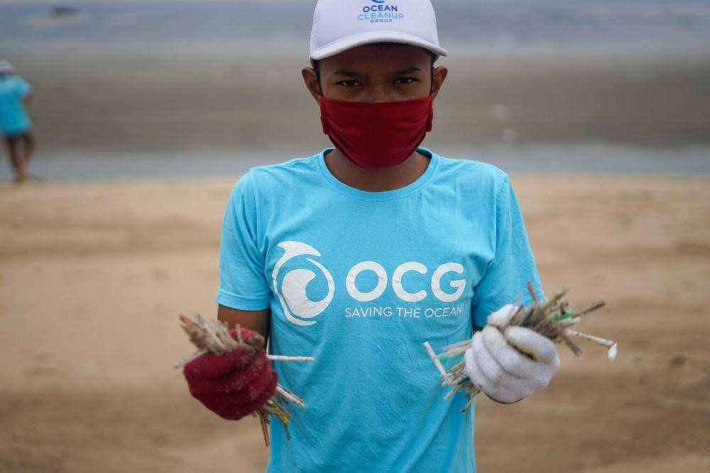 ilustrasi orang membersihkan sampah di pantai