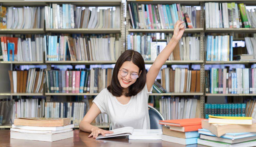 Seorang perempuan di perpustakaan (Shutterstock/Qilin'sPranceFilmmaker)