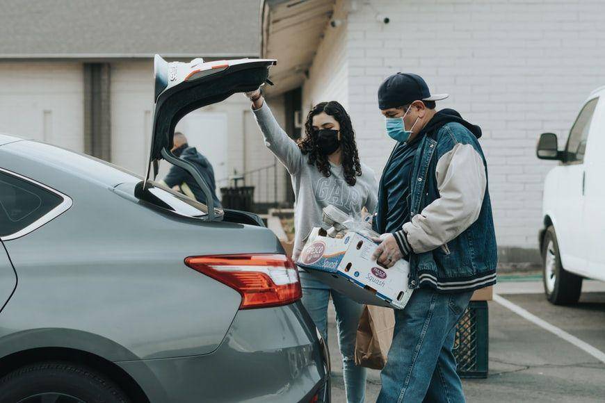 potret seorang wanita yang sedang membantu seorang pria membuka pintu belakang mobil (unsplash.com/Ismael Paramo)