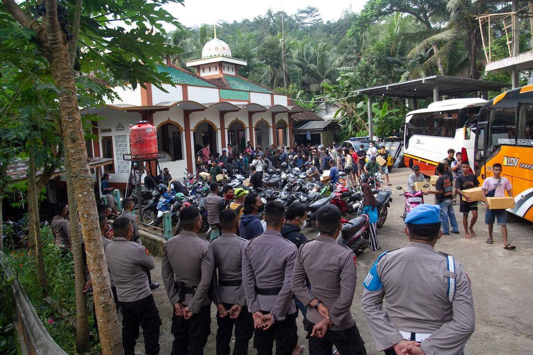 Anggota Polisi berjaga saat warga yang sempat ditahan tiba di halaman masjid Desa Wadas, Bener, Purworejo, Jawa Tengah, Rabu (9/2).