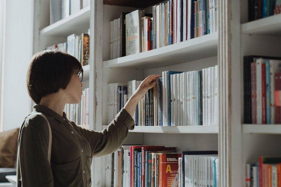ilustrasi perempuan memilih buku (pexels.com/cottonbro)