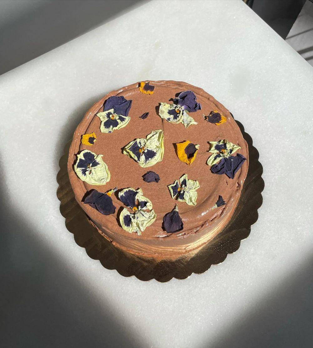 kue cokelat dengan edible flower (instagram.com/halfbirthdaychi)