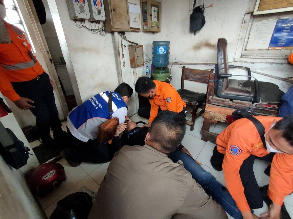 Patugas saat mengevakuasi pria selamat usai tertabrak kereta api, Selasa (16/8/2022). (Dok. Command Center Surabaya)