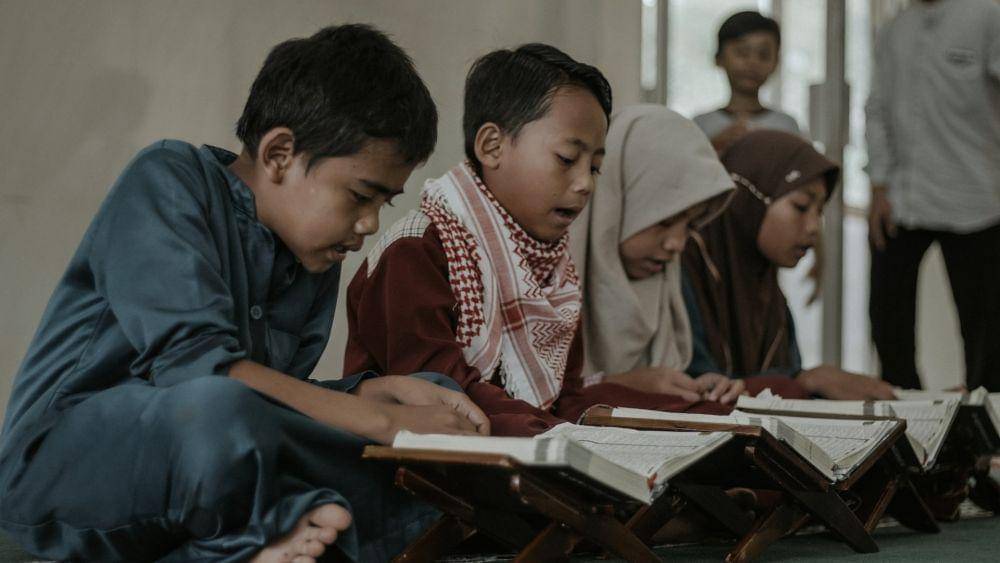 ilustrasi anak-anak sedang membaca Al-Qur'an(unsplash.com/Andri Helmansyah)