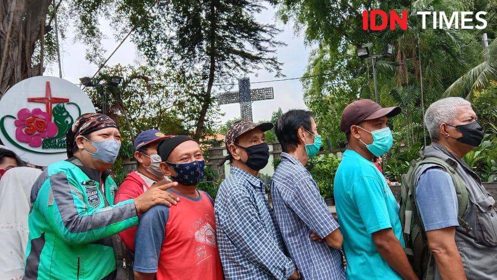 Sejumlah warga dari beragam profesi mengantre untuk mendapatkan makan siang gratis di Gereja Paroki Santa Theresia Bongsari Semarang. (IDN Times/Fariz Fardianto)