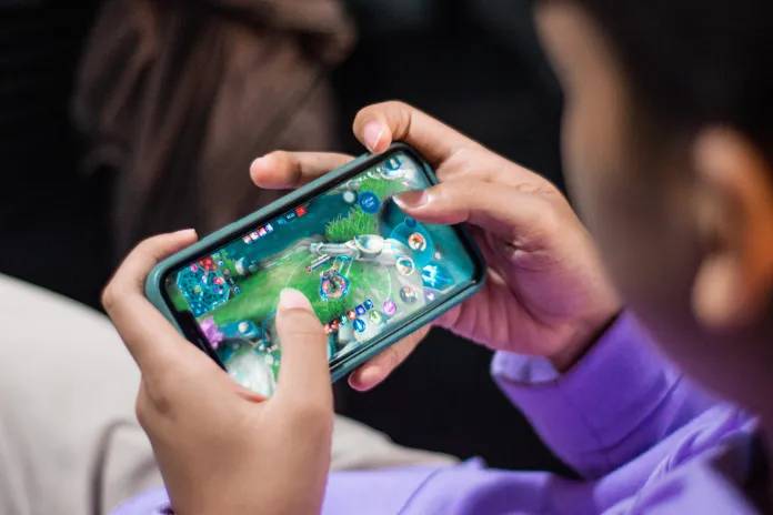 Seseorang sedang bermain game mobile (moviesgameandtech.com)