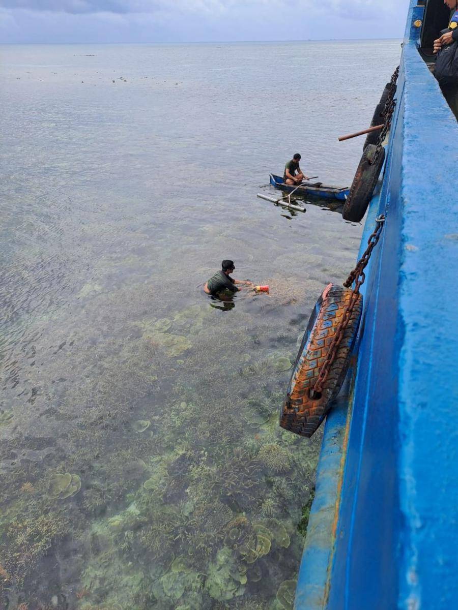Dua orang tampak berenang di samping lambung kapal tanker LCT Serasi IX yang terdampar di Pulau Gosong Kepulauan Karimunjawa. (IDN Times/Dok Humas Polda Jateng)
