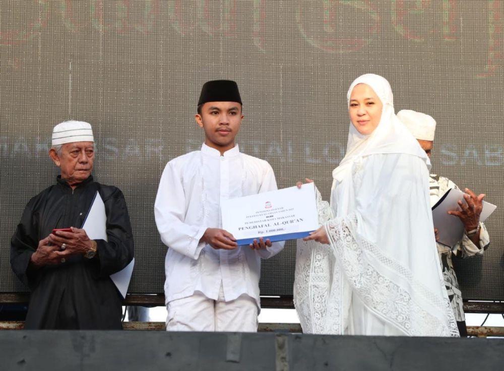 Wakil Wali Kota Makassar Fatmawati Rusdi (kanan) menyerahkan bantuan dari Pemerintah Kota kepada penghapal Alquran. (Dok. Humas Pemkot Makassar)