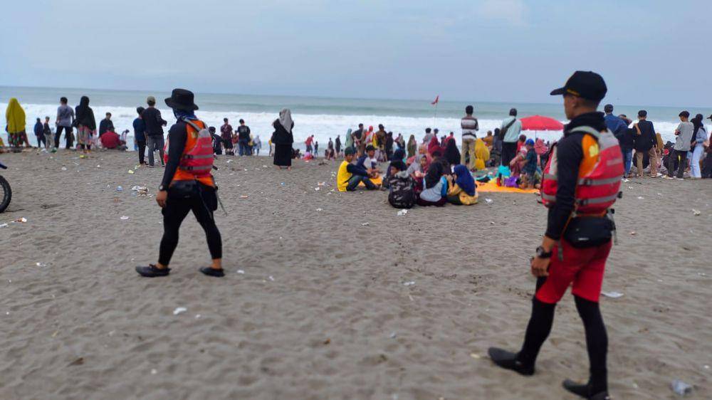 Dua personel tim SAR Cilacap berjalan kaki sambil menelusuri tiga wisatawan yang hilang ditelan ombak laut selatan Kebumen. (IDN Times/Dok Humas Basarnas Cilacap)
