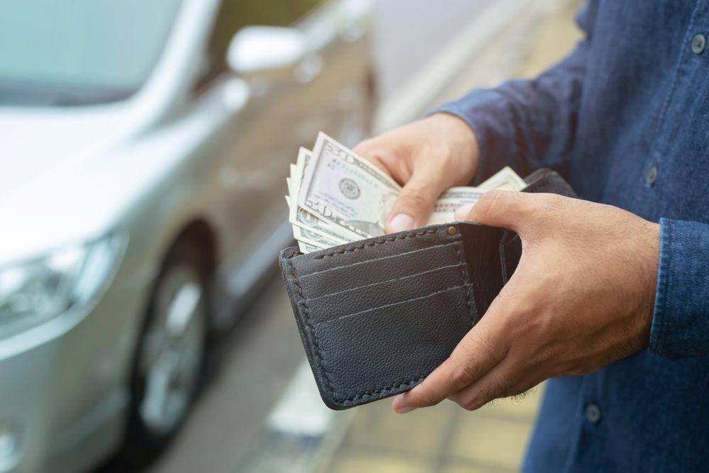 Ilustrasi menggunakan uang cash untuk transaksi (Shutterstock/fongbeerredhot)
