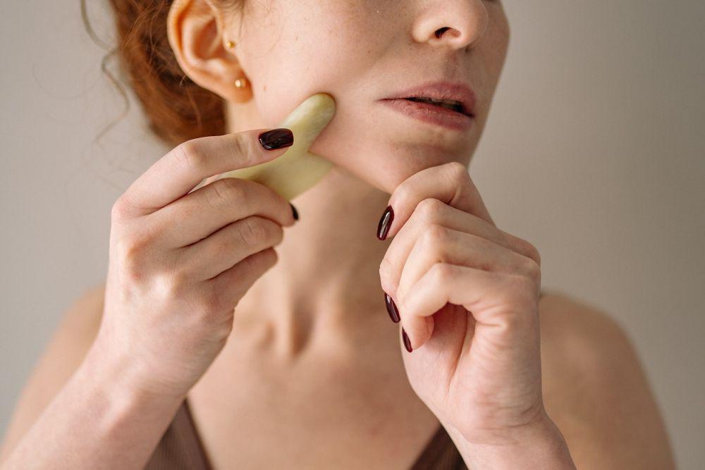 Memijat wajah dengan gua sha ke arah atas (pexels.com/Yan Krukau)