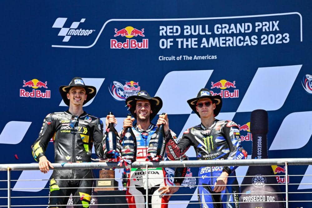 Luca Marini berada di podium GP Amerika 2023 bersama Alex Rins dan Fabio Quartararo. (motogp.com)