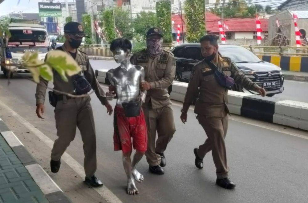 Penertiban pengamen manusia silver di lampu merah bawah plyover Banjarmasin.