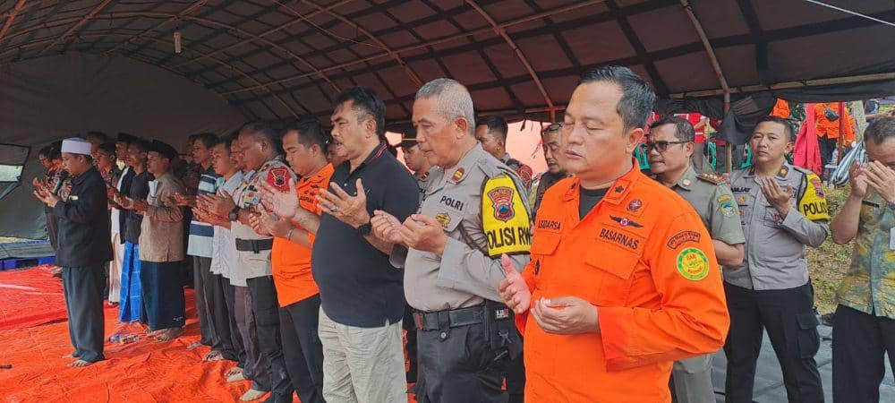 Para personel tim SAR gabungan saat memanjatkan doa bersama kerabat keluarga penambang emas yang tidak ditemukan di lubang galian reruntuhan wilayah Ajibarang Banyumas. (IDN Times/Dok Humas Basarnas Cilacap)