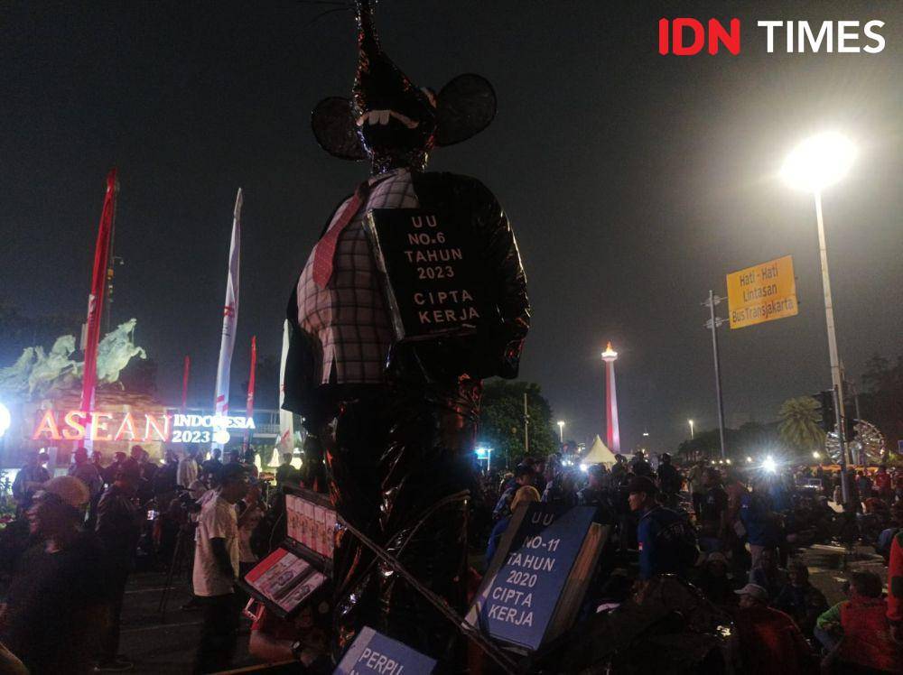 Patung tikus berdasi berdiri tegak di atas mobil bak terbuka saat demo buruh di Patung Kuda Arjuna Wiwaha pada Kamis (10/8/2023). (IDN Times/Dini Suciatiningrum)