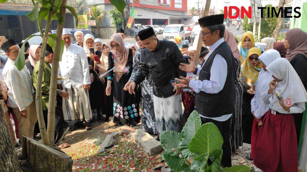 Guru dan murid melakukan tabur bunga di lokasi kecelakaan. (IDN Times/Imam Faishal)