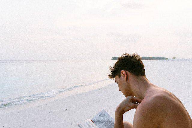 ilustrasi membaca buku di pantai (pexels.com/Martin Péchy)