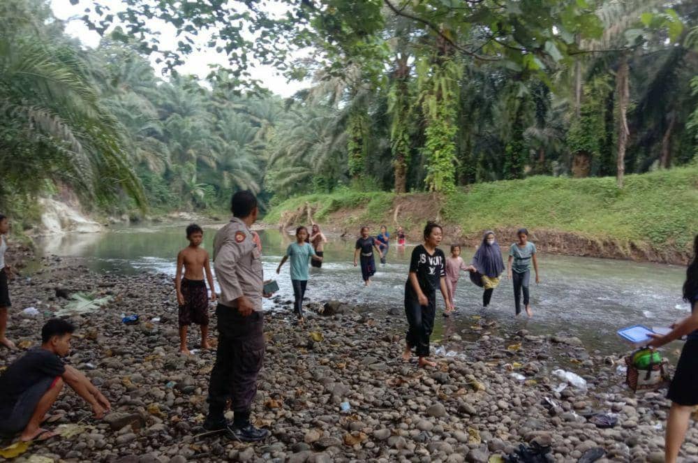 Petugas dibantu warga mencari pelajar hanyut disungai Langkat (IDN Times/ istimewa)