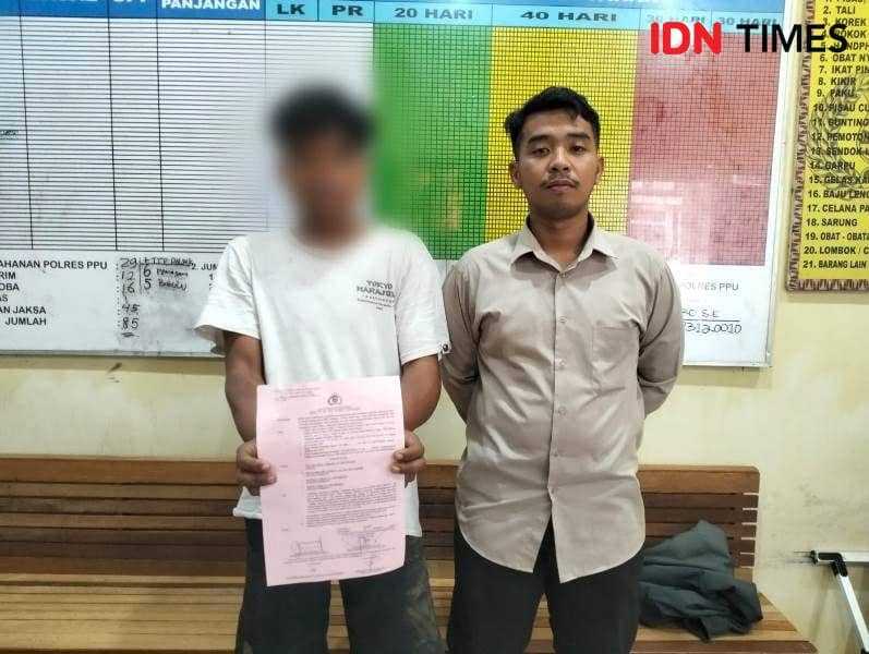 Tersangka MN saat diamankan di Polres PPU dikawal anggota Reskrim (IDN Times/Ervan)