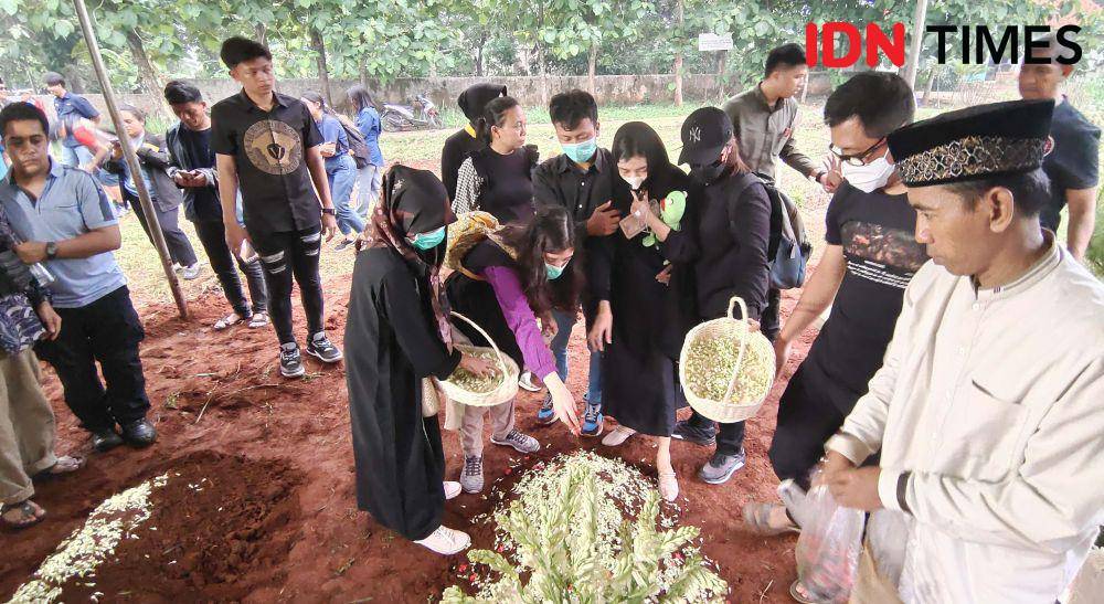Ibu korban bersama keluarga menamburkan bunga di salah satu empat anak yang menjadi korban pembunuhan dan dimakankam di TPU Bedahan, Sawangan, Kota Depok. (IDNTimes/Dicky)