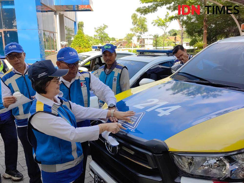 Dirut PT JSN, Merry Natacha Panjaitan memasang stiker ke kendaraan dinas jelang Nataru 2023. (IDN Times/Larasati Rey)