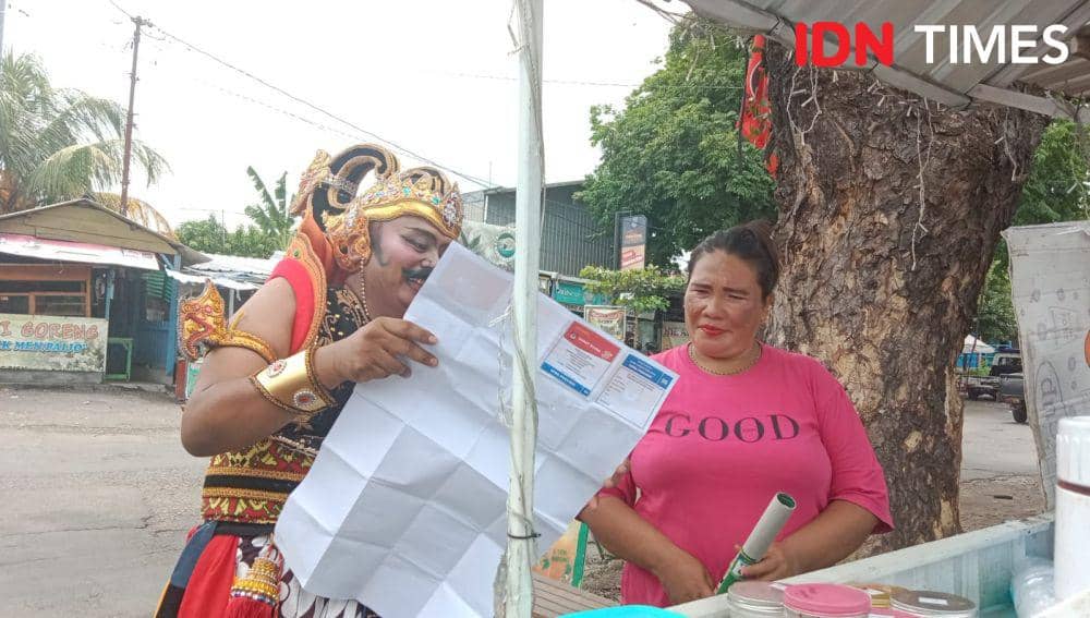Caleg PKB bernama Nanang Fardiansyah saat menunjukkan contoh surat suara kepada warga untuk menyosialisasikan tahapan coblosan Pemilu 2024. (IDN Times/Fariz Fardianto)