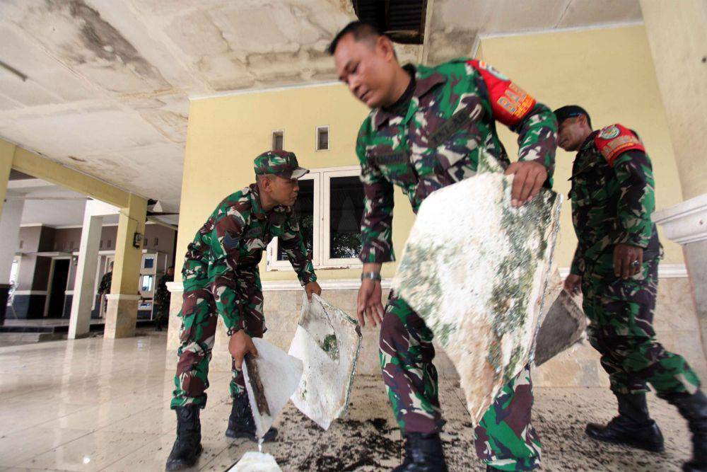Sejumlah personel TNI AD membersihkan sisa bangunan yang rusak terdampak ledakan gudang peluru di Desa Parung Pinang, Ciangsana, Gunung Putri, Kabupaten Bogor, Jawa Barat, Senin (1/4/2024). (ANTARA FOTO/Yulius Satria Wijaya)