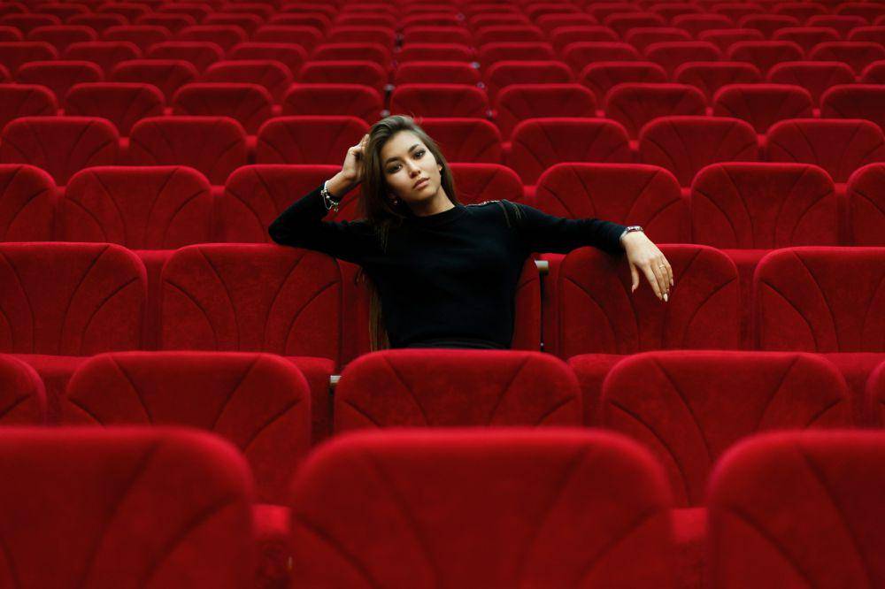 https://unsplash.com/photos/woman-in-black-long-sleeve-shirt-sitting-on-red-chair--w-V5GRG9-0