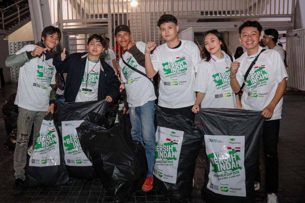 Pegadaian gelar kegiatan bersih-bersih di Stadion Gelora Bung Karno Jakarta setelah pertandingan Indonesia vs Irak, pada Kamis lalu (06/06). Kegiatan ini merupakan bentuk komitmen Pegadaian dalam penerapan Tujuan Pembangunan Berkelanjutan nomor 11, yaitu kota dan permukiman yang berkelanjutan. (Dok. Pegadaian)