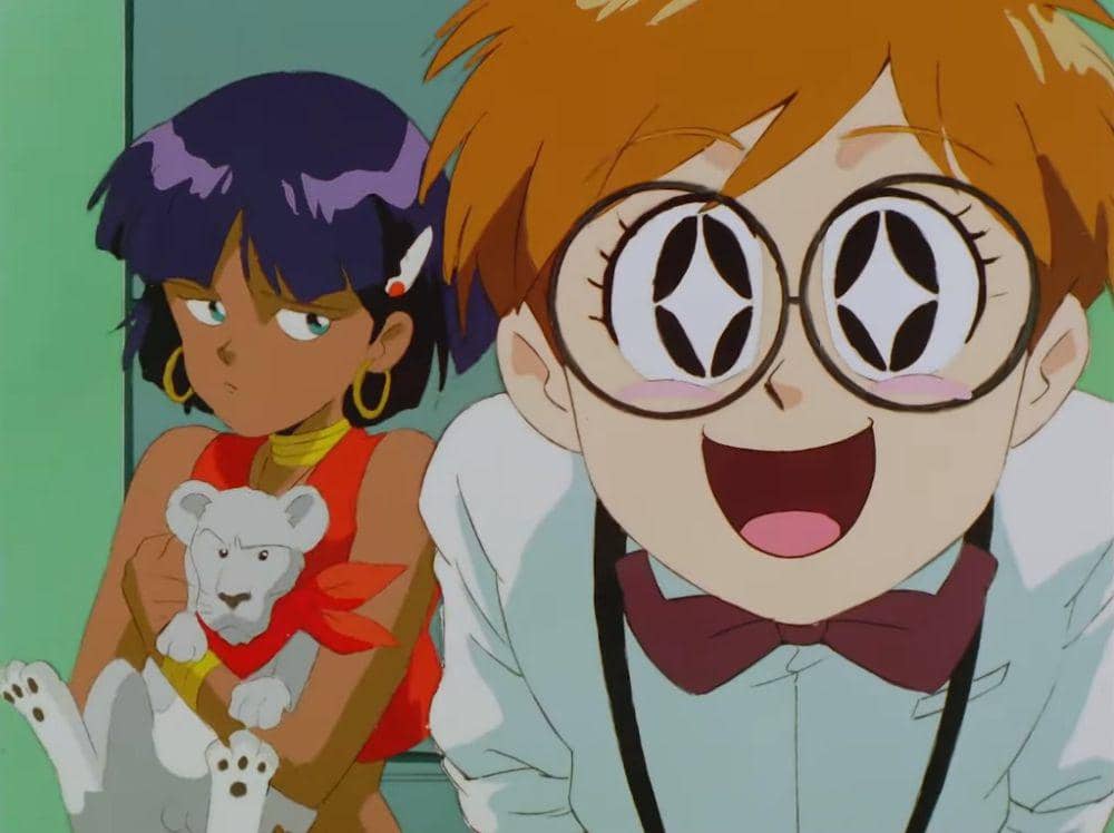 Dua karakter anime dari Nadia: The Secret of Blue Water, seorang gadis berambut ungu memegang anak singa putih dan seorang anak laki-laki berkacamata besar tersenyum lebar.