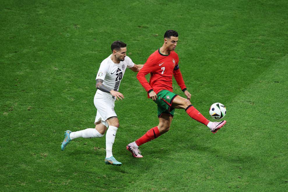 Cristiano Ronaldo (merah) mengamankan bola untuk Portugal di Euro 2024. (uefa.com)