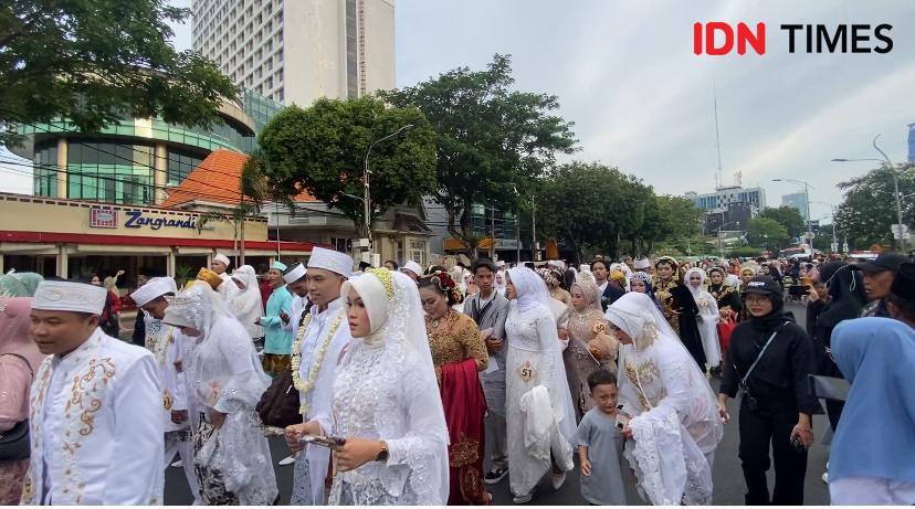 Ratusan peserta resepsi akbar isbat nikah massal saat diarak, Selasa (2/7/2024). (IDN Times/Khusnul Hasana)