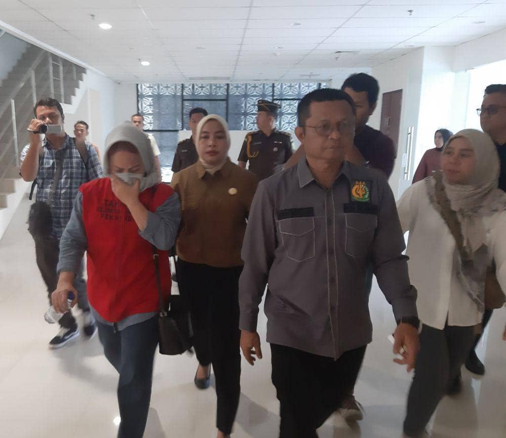 Menggunakan rompi tahanan, Dewi terpidana kasus penipuan saat digiring tim Intelijen Kejati Riau (IDN Times/ Fanny Rizano)