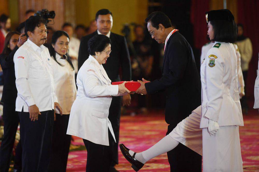 Ketua Dewan Pengarah Badan Pembinaan Ideologi Pancasila (BPIP) Megawati Soekarnoputri (ketiga kiri) menyerahkan duplikat bendera pusaka kepada Gubernur DIY Sri Sultan Hamengku Buwono X (kedua kanan) disaksikan Kepala BPIP Yudian Wahyudi (kiri) dan Menteri Pemberdayaan Perempuan dan Perlindungan Anak (PPPA) I Gusti Ayu Bintang Darmawati (kedua kiri) saat upacara penyerahan duplikat bendera pusaka kepada gubernur seluruh Indonesia di Jakarta, Senin (5/8/2024).  ANTARA FOTO/Akbar Nugroho Gumay/nz