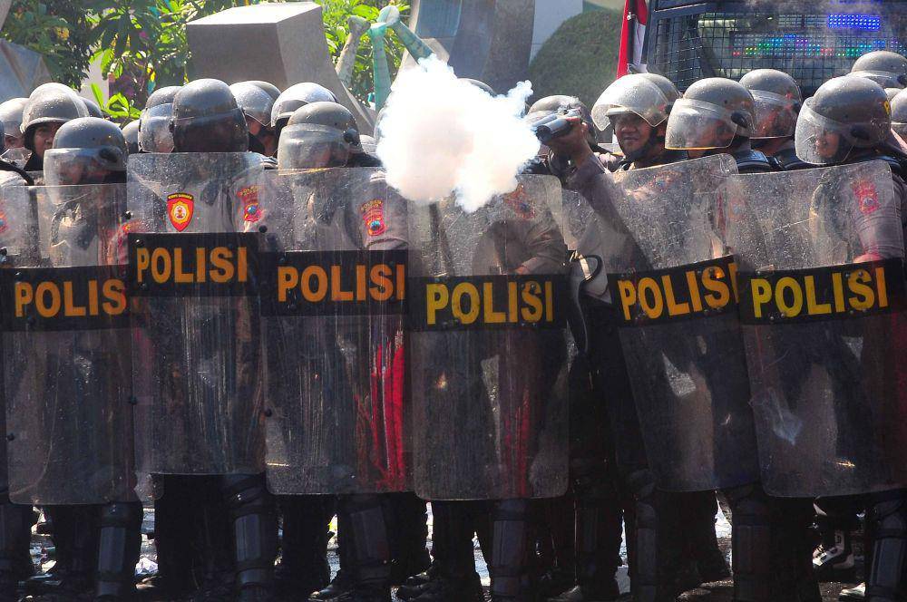 Pasukan Pengendalian Massa (Dalmas) menembakkan gas air mata kepada pengunjuk rasa yang anarkis saat simulasi sistem pengamanan kota (Sispamkota)