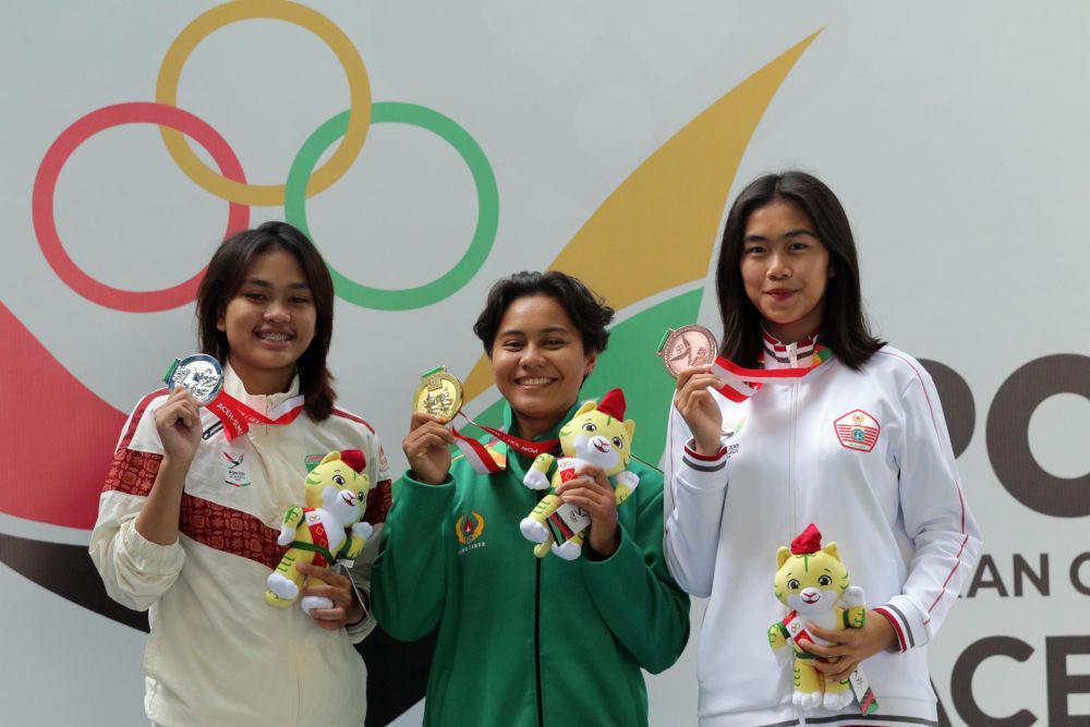 Atlet Loncat Indah Jatim Gladies Lariesa Garina Hagakore (tengah) bersama atlet Sumsel Adreva Rasty Putri (kiri) dan atlet DKI Jakarta Nur Mufiidah Sudirman menunjukkan medali saat acara penyerahan medali final nomor papan 1 meter putri PON XXI Aceh-Sumut di Kolam Renang Selayang, Medan, Sumatra Utara, Rabu (11/9/2024). (PB PON Sumut/Daniel Effendi Siregar)
