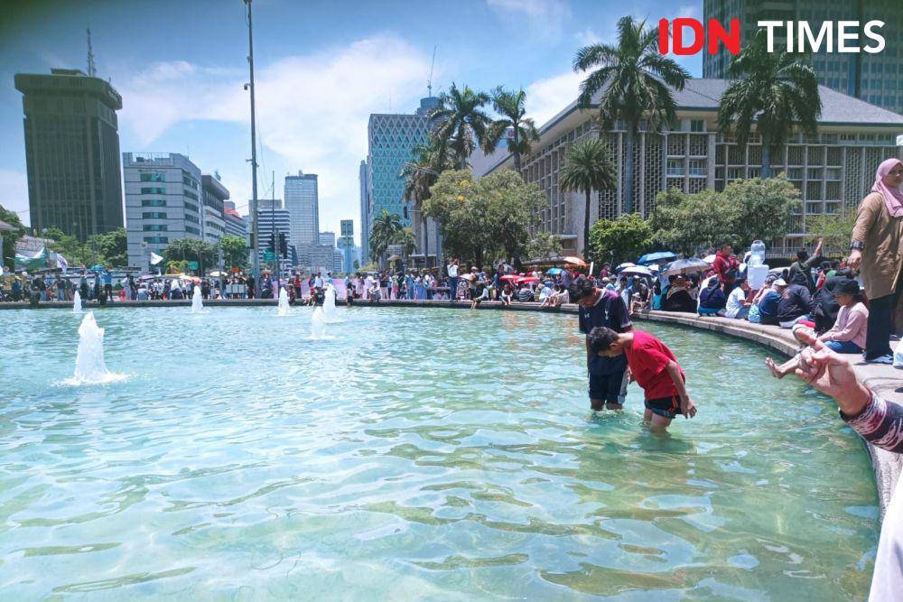 Anak-anak berenang di air mancur patung kuda saat pelantikan Prabowo-Gibran pada Minggu (20/10/2024). (IDN Times/Dini Suciatiningrum)
