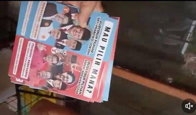 Tangkap layar video diduga Timses RIDO pasang stiker perbandingan dukungan yang didapat Ridwan Kamil dan Pramono (X.com/@GunRomli)