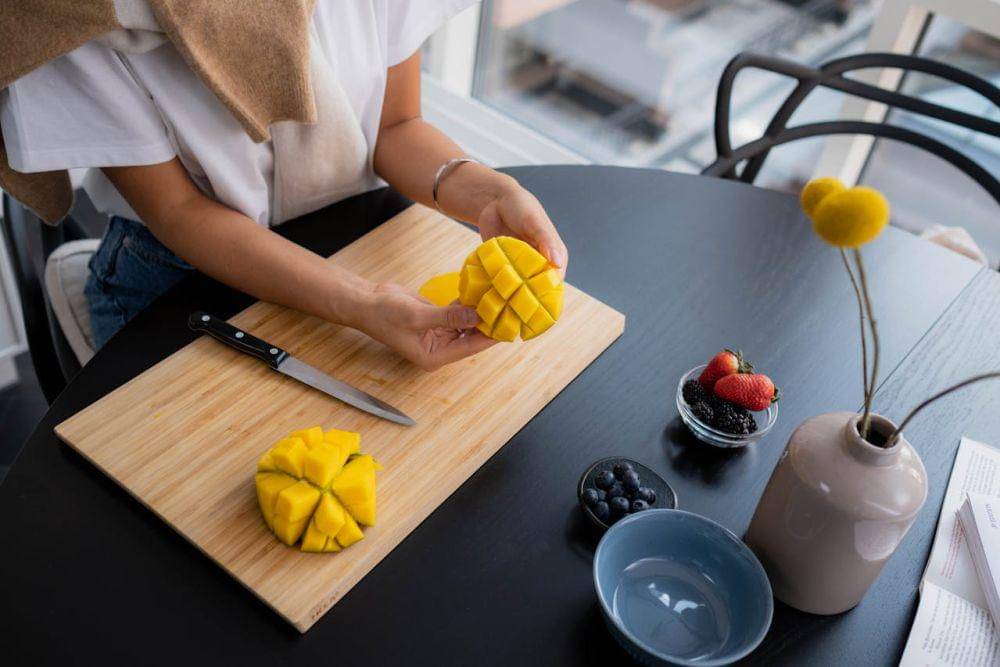 Potret memotong buah mangga 