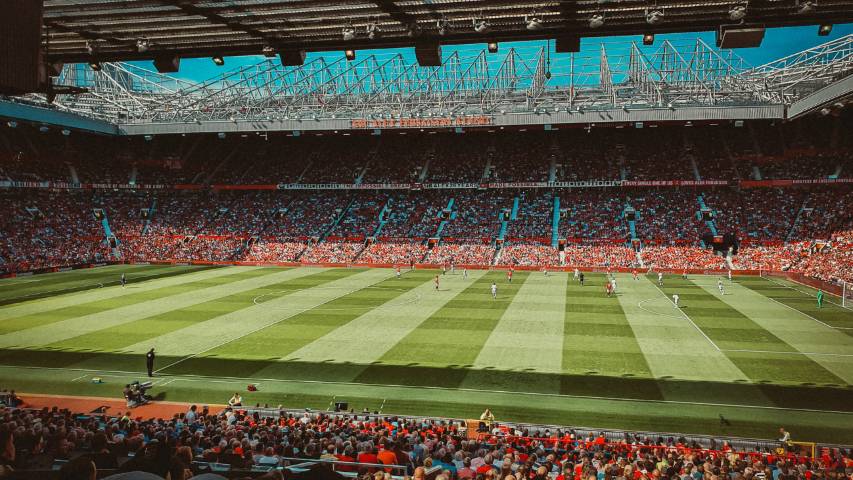 Ilustrasi suasana pertandingan di stadion Old Trafford. (unsplash.com/reganography)