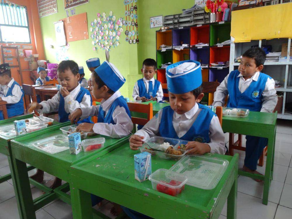 Siswa di Tulungagung menikmati paket MBG yang dibagikan pemerintah. IDN Times/ Bramanta Pamungkas