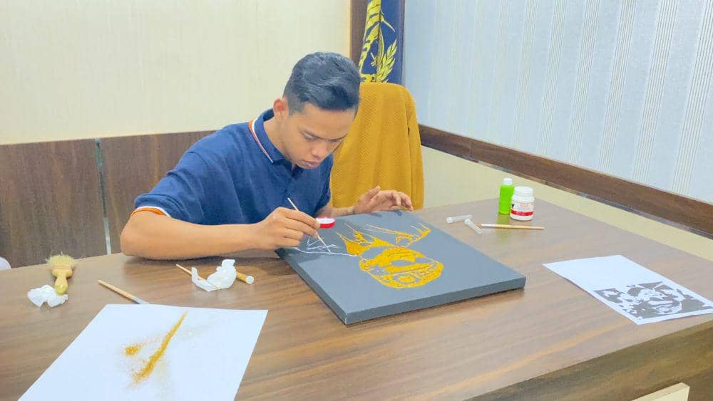 Deni sedang membuat lukisan potret Presiden Prabowo Subianto (Foto: Lapas Suliki)
