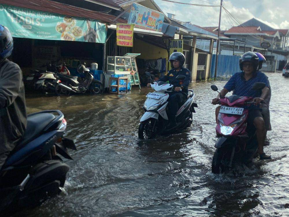 Sejumlah pengendara motor menerabas Banjir di Banjarmasin